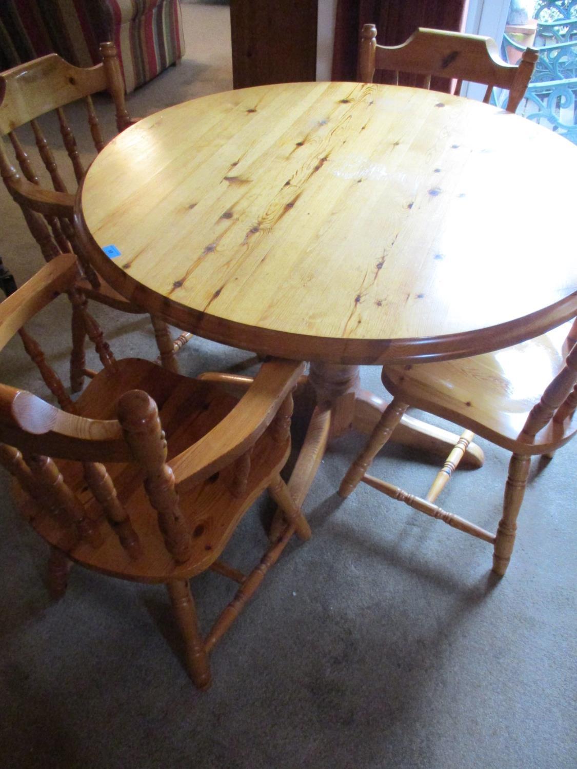 A late 20th century pine breakfast table, together with two matching carvers and two dining chairs