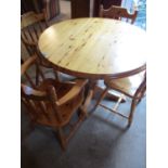 A late 20th century pine breakfast table, together with two matching carvers and two dining chairs