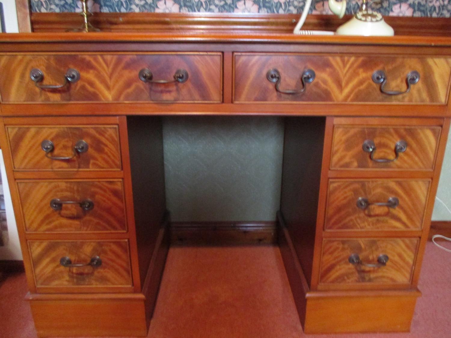 A reproduction mahogany twin pedestal desk, two long drawers above short drawers, 31" x 42" x 20"