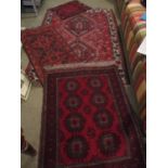 A Turkish red ground gull decorated rug with a small Bokhara prayer mat with red ground and barbers?