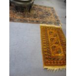 A large blue ground Middle Eastern rug, together with a smaller yellow ground rug