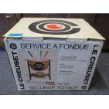 A boxed Le Cruset service and a fondue set