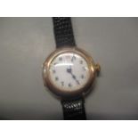 An early 20th century ladies 9ct gold wristwatch having a white enamel dial with Arabic numerals