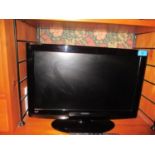 An Hitachi flat screen 18" television with remote
