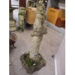 A reconstituted stoneware garden statue of a female sitting on top of a large column, 33 1/4" x 13