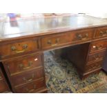 An early 20th century mahogany, twin pedestal desk having a green/brown leather scriber Position:RAM