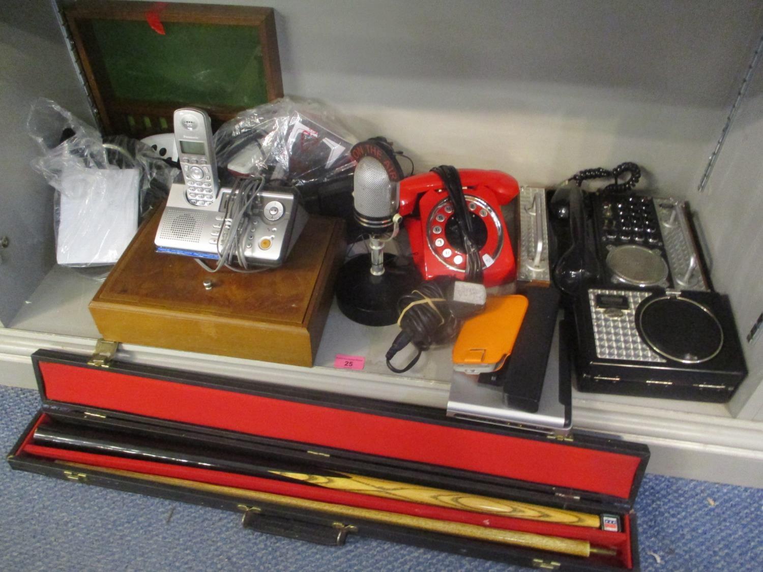 A mixed lot to include a snooker cue, telephones and portable DVD player