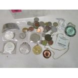 A selection of coins and badges to include an 1896 US one dollar coin, a Maria Theresa silver