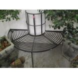 A wrought iron black painted tree bench, 38 1/2" h x 56"w and two aluminium black painted garden