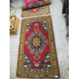 Two Afghanistan rugs, red ground, triple guard borders, each 62" x 35 1/2"Position:Stage