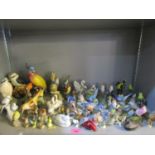 A collection of porcelain and pottery bird figurines to include Beswick, Metzler and Ortififf, Royal