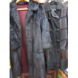 A bull skin short hair and leather ladies, knee length coat, circa 1960, with fabric buttons,