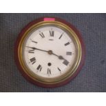 An early 20th century brass cased ships clock mounted on a treen base