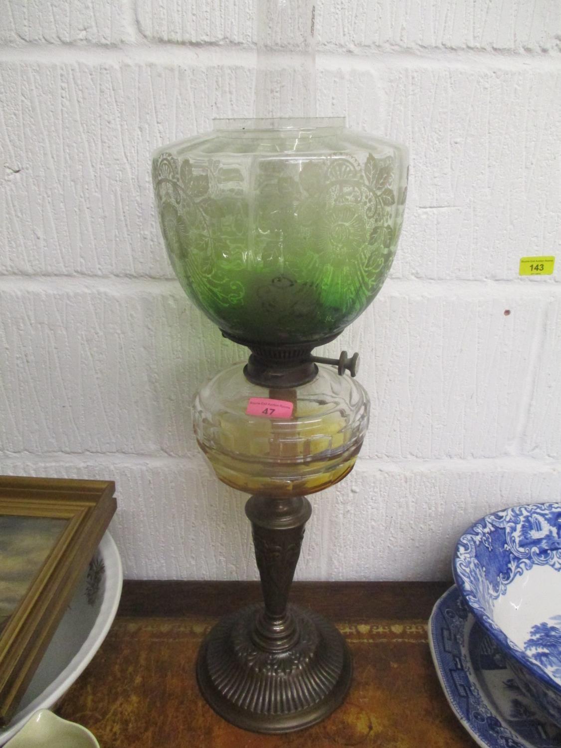 A Victorian cast metal and clear glass oil lamp with a green etched shade, 26 1/2"h