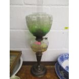 A Victorian cast metal and clear glass oil lamp with a green etched shade, 26 1/2"h