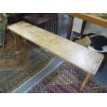 A pine low bench having wrought iron supports, 16 3/4"h x 54"w