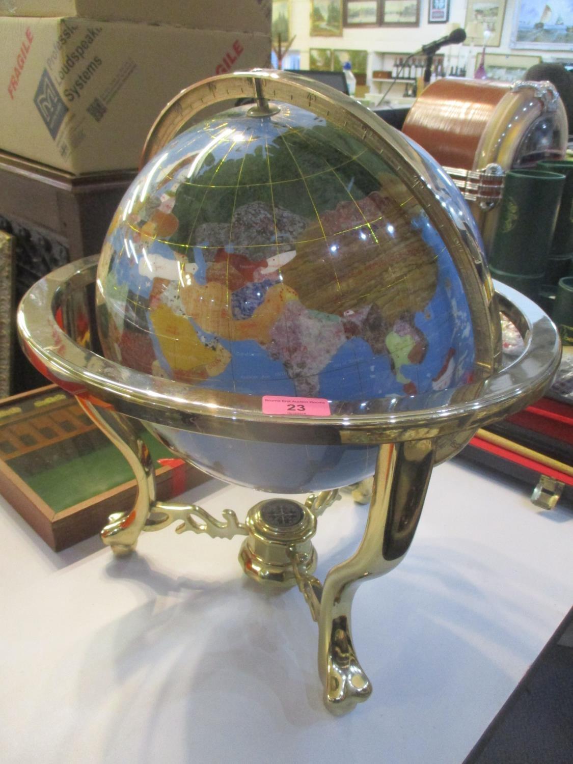 A modern table top globe inset with semi precious stones