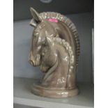 A china model of a mare and her foal's heads, unsigned, painted grey
