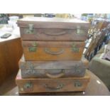 Four vintage leather bound suitcases