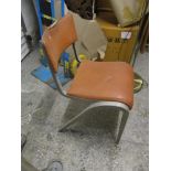 A mid 20th century aluminium framed chair with a leatherette upholstered back and seat with an