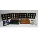 Twenty four silver coins from the Conservation Collection, contained in a hardwood case with four