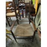 An Arts & Crafts beech and oak lathe back chair with a rush seat, on turned legs