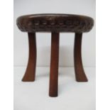 A mid 20th century burr walnut and oak stool with thumb moulded, carved decoration, on splayed legs,