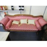 A Victorian Mahogany Chesterfield with carved decoration upholstered, with bolster and matching