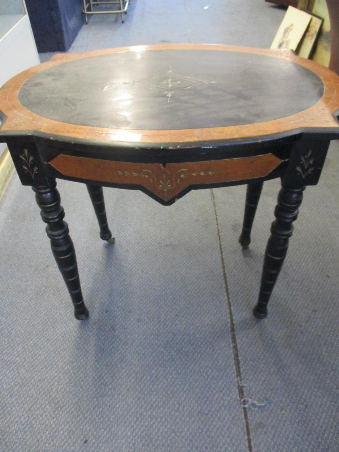 A Victorian ebonized sewing table