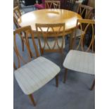 A retro G-Plan Circa 1960's teak circular extending dinning table with six matching chairs having