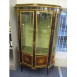 A Louis XV1 serpentine fronted mahogany finished vitrine having applied, gilt metal mounts,