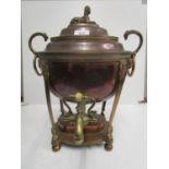 A Georgian copper tea urn with domed lid and sphinx finial, bird of prey head and ring handles,