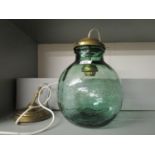 A Versa green glass carboy converted to a pendant lamp