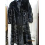 Circa 1970, a Scottish black mink coat, calf-length, with four black buttons, 41" long x 36"