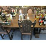 A modern plank constructed oak refectory style table and six chairs to include two carvers and