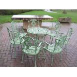 A green painted cast aluminum circular Garden Table and seven Chairs of two designs