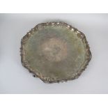 A George II large silver shaped circular Salver engraved vacant rococo cartouche on four pad feet,