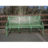 A green painted wrought iron Garden Bench on scroll supports 5ft 4in W