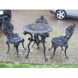 A black painted cast iron small circular Garden Table and three Chairs