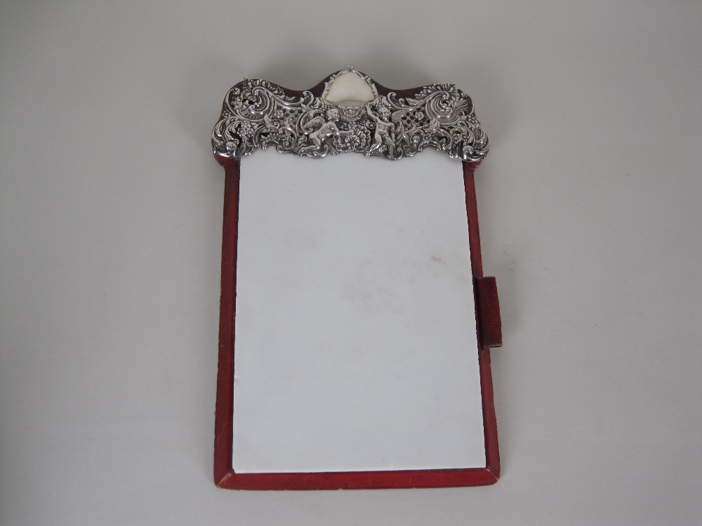 A Victorian Note Pad with silver surmount embossed cherubs, flowers, scrolls, etc, London 1897,