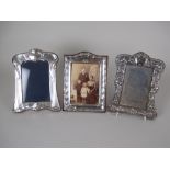 An Edward VII Art Nouveau silver Photograph Frame, Birmingham 1904 and two other embossed Photograph