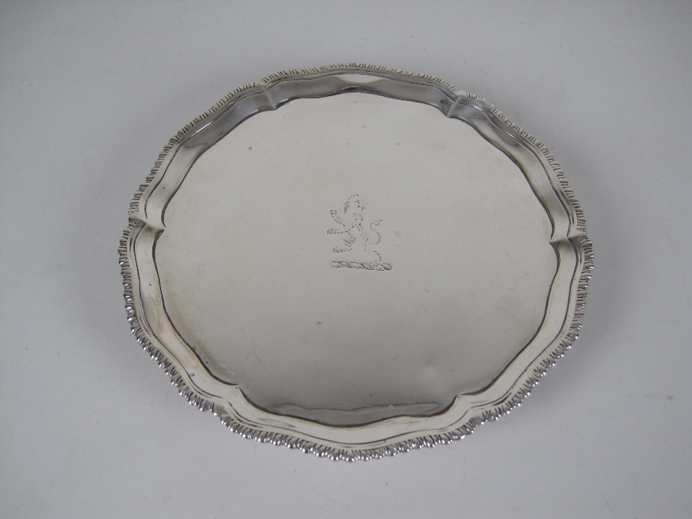 A George III silver circular Waiter engraved crest, gadroon rim on hoof feet, London 1773, 7in,