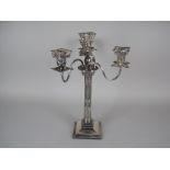A plated three branch, four light Candelabrum on fluted column with swag, beaded and corinthian