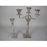 A pair of Elizabeth II silver Candlesticks with corinthian capitals on beaded, stepped square bases,