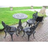 A black painted cast iron small circular Table and three Chairs