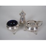 A George VI silver three piece circular Condiment Set on hoof feet, Chester 1937