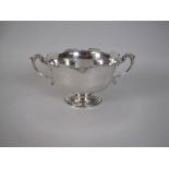 A George V silver two handled Rose Bowl with scallop and shaped rim on pedestal base, Birmingham