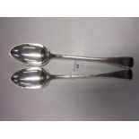 A pair of George IV silver Basting Spoons with feather edges, engraved crests, London 1820,