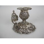 A George IV silver Taperstick and Snuffer with floral embossing, leafage scroll handle and scroll