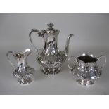 A Victorian silver three piece Coffee Service with floral and scroll embossing, the coffee pot